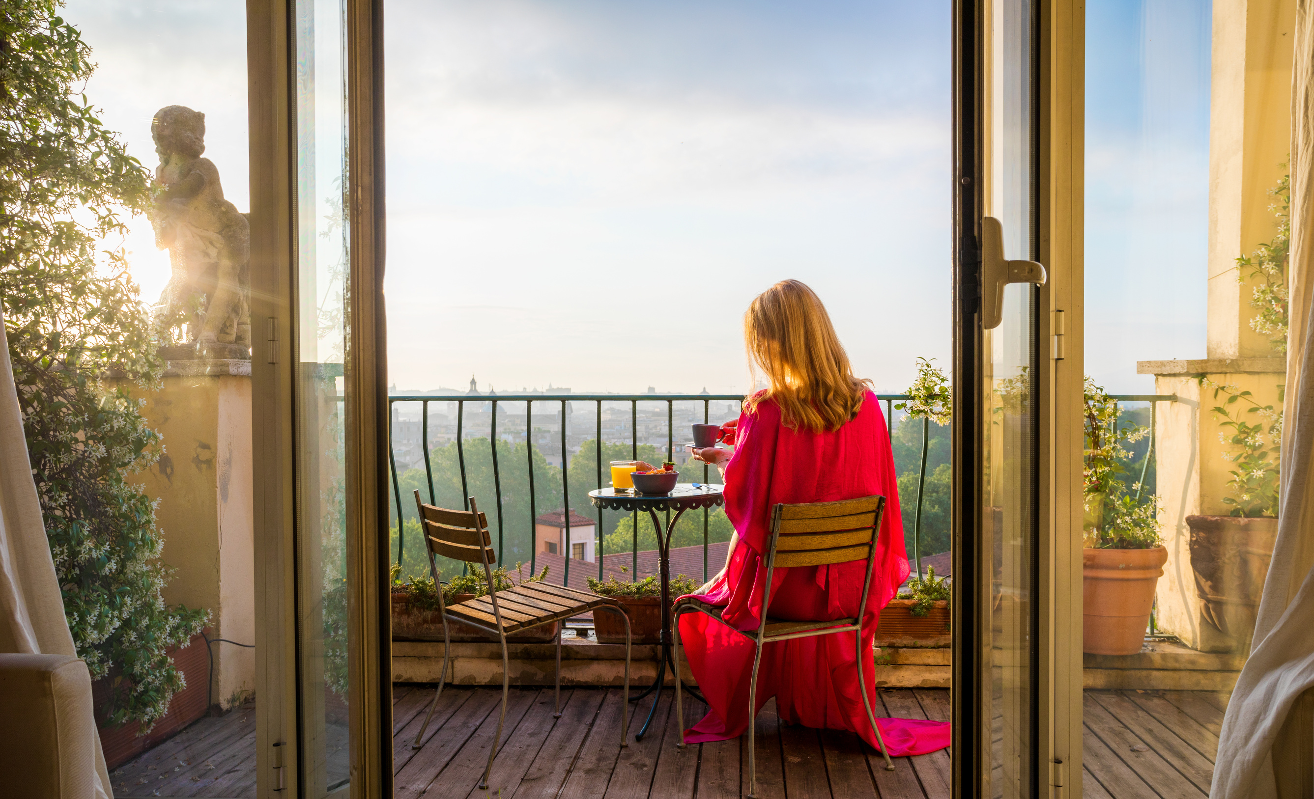 Woman Sitting on Balcony Having Breakfast